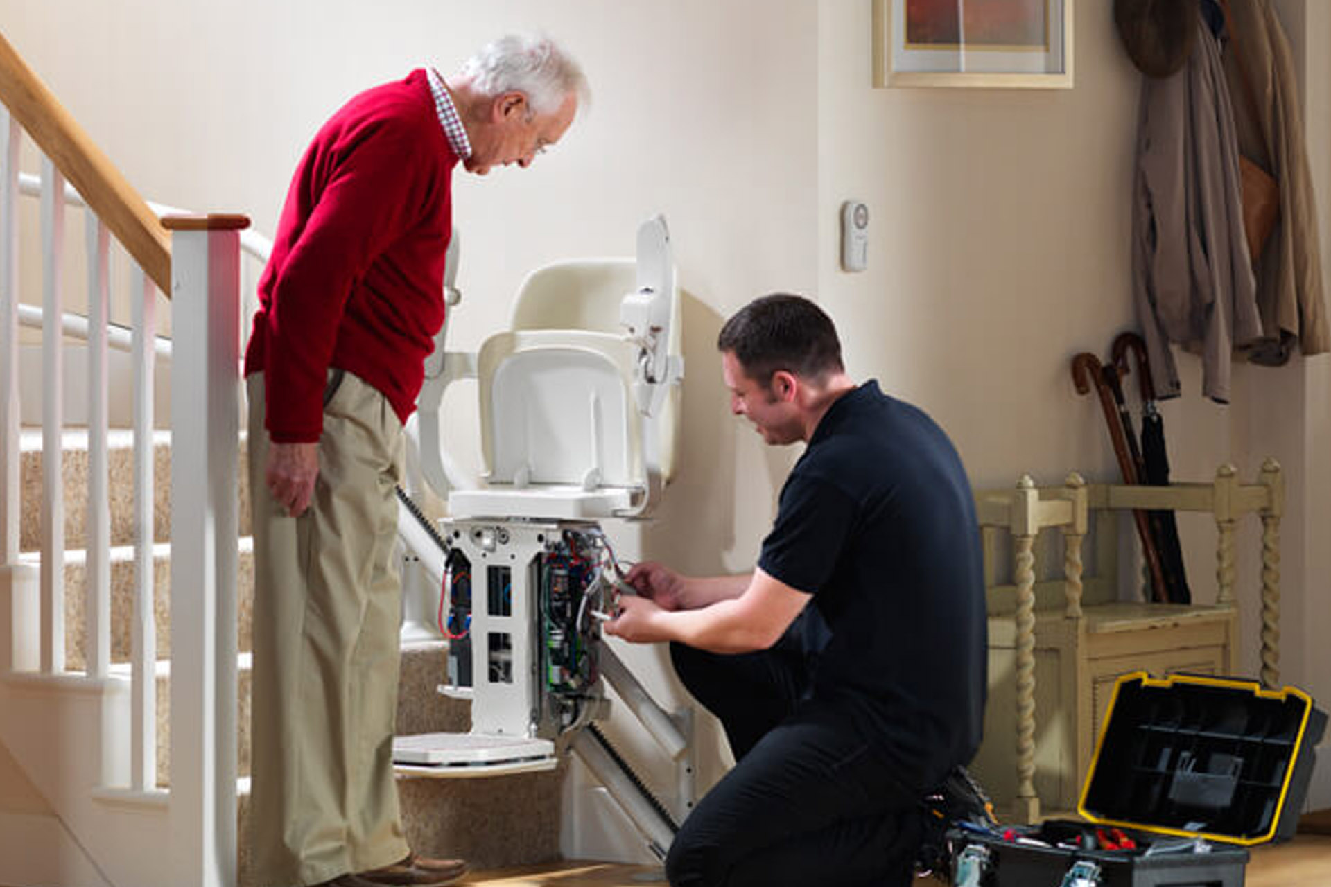 Dolphin stairlift repairs Galway, Ireland — engineer repairing a Handicare stairlift at home